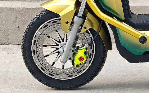 Electric Motorcycle | Front Wheel & Disc Brake Detail Electric motorcycle front wheel and hydraulic disc brake close-up, high-performance braking system for safe riding