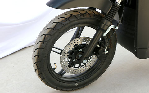 Delivery Electric Motorcycle | Front Wheel & Disc Brake Detail Heavy-duty delivery electric motorcycle front wheel and hydraulic disc brake close-up, high-performance braking system for safe riding