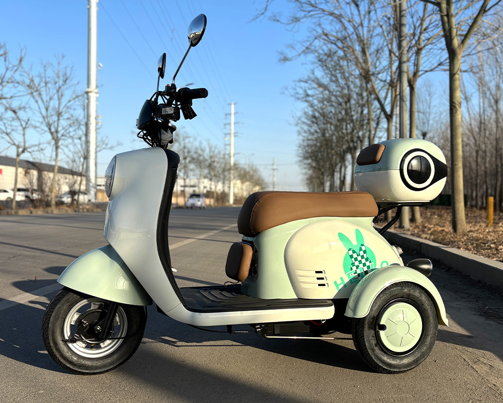 V1 Electric Tricycle | Light Green Rabbit Side View V1 light green electric tricycle side view, 3-wheel mobility scooter with cute rabbit decal and baby seat for seniors & family
