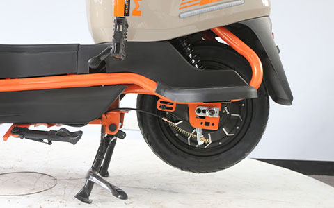 Electric Scooter | Rear Wheel & Frame Side Detail Rear wheel and sturdy frame of beige-orange electric scooter, durable structure for daily commuting