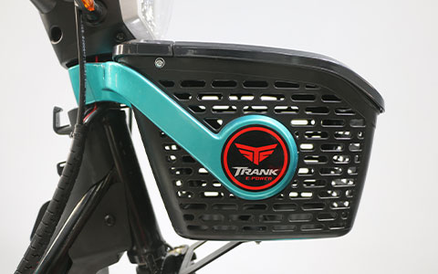 Electric Bicycle | Front Metal Basket Detail Sturdy metal front storage basket mounted on teal electric bike head, practical cargo basket design