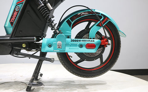 Electric Bike | Rear Wheel & Suspension Detail Alt: Large rubber rear wheel with hydraulic disc brake and shock absorber, durable wheel structure for electric bicycle Title: Electric Bicycle | Big Wheel & Disc Brake Suspension Detail