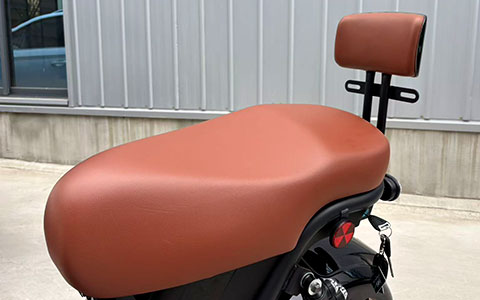 Electric motorcycle comfortable saddle with rear backrest, ergonomic brown leather seat for long-term riding without fatigue