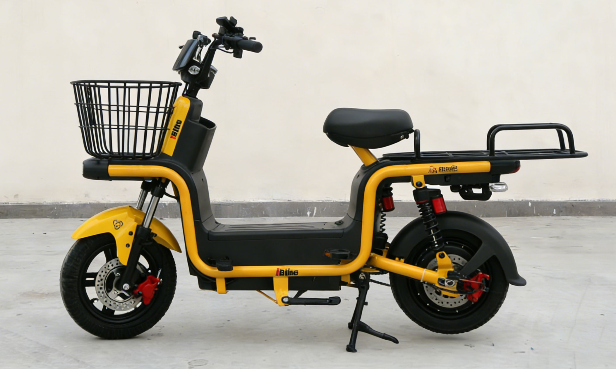 Bright yellow and black electric bike with front basket, dual disc brakes, rear shock absorption, and rear cargo rack for urban commuting