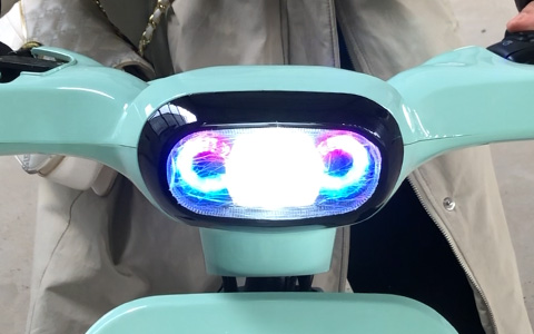 Dual LED colorful headlight of mint green H1 electric bike, bright illumination with decorative light rings