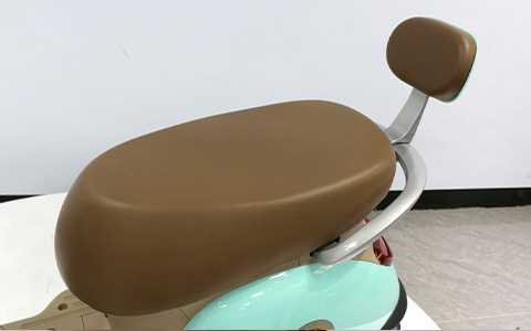 Brown ergonomic saddle with backrest for retro mint green electric scooter, comfortable seat for long rides